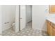 Bathroom with stylish tile flooring, white door, and natural wood vanity at 3221 E Lynx Pl, Chandler, AZ 85249