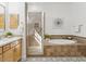 Elegant bathroom features a soaking tub with tile surround and a glass enclosed shower at 3221 E Lynx Pl, Chandler, AZ 85249