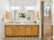 Bathroom with double sinks, decorative tiling and a glass shower door at 3221 E Lynx Pl, Chandler, AZ 85249