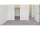 A bright bedroom with neutral carpet features an ensuite bathroom and closet at 3221 E Lynx Pl, Chandler, AZ 85249