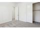 Neutral bedroom with plush carpet features an ensuite bathroom and a closet at 3221 E Lynx Pl, Chandler, AZ 85249