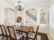 Dining room featuring tile floors, decorative chandelier, and staircase in view at 3221 E Lynx Pl, Chandler, AZ 85249