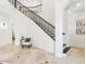 Elegant foyer with staircase, travertine floors, and accent furniture at 3221 E Lynx Pl, Chandler, AZ 85249