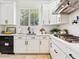 Modern kitchen featuring white cabinets, stainless steel appliances, and gas cooktop at 3221 E Lynx Pl, Chandler, AZ 85249