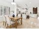 Open concept kitchen featuring white cabinets, center island, and dining area at 3221 E Lynx Pl, Chandler, AZ 85249