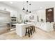 Spacious kitchen with white cabinets, stainless steel appliances, and a center island at 3221 E Lynx Pl, Chandler, AZ 85249