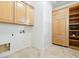 Bright laundry room with ample cabinet space and tile flooring at 3221 E Lynx Pl, Chandler, AZ 85249