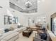 Open-concept living room with a view of the staircase and kitchen, featuring a cozy sectional sofa at 3221 E Lynx Pl, Chandler, AZ 85249