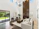 Open-concept living room featuring a modern fireplace, soaring ceilings, and backyard access at 3221 E Lynx Pl, Chandler, AZ 85249