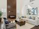 Spacious living room showcases a modern fireplace, high ceilings, and a comfortable sectional sofa at 3221 E Lynx Pl, Chandler, AZ 85249