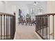 Upstairs living space with decorative railing, open layout, and view of the living room below at 3221 E Lynx Pl, Chandler, AZ 85249
