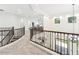 Open loft with views to the living room below, decorative railings, and staircase at 3221 E Lynx Pl, Chandler, AZ 85249