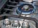 Close up of a gas cooktop with stainless steel knobs at 3221 E Lynx Pl, Chandler, AZ 85249