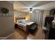 Cozy bedroom with a wooden bed frame, ceiling fan and neutral color palette at 3535 W Monte Cristo Ave # 129, Phoenix, AZ 85053