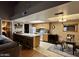 The kitchen offers bar stool seating, oak cabinets and is open to the living and dining spaces at 3535 W Monte Cristo Ave # 129, Phoenix, AZ 85053