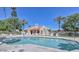 Community pool area with lounge chairs, palm trees, and a clear blue pool at 3535 W Monte Cristo Ave # 129, Phoenix, AZ 85053