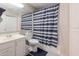 The full bathroom includes a single sink vanity, standard toilet, and a shower with a striped curtain at 3755 E Broadway Rd # 36, Mesa, AZ 85206