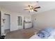 Bright bedroom features neutral walls, a ceiling fan, carpet, and a dresser with mirror at 3755 E Broadway Rd # 36, Mesa, AZ 85206