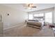 Neutral bedroom with carpet has ceiling fan and a bed with a mirrored frame and headboard at 3755 E Broadway Rd # 36, Mesa, AZ 85206