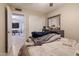 Bright bedroom features neutral walls, tile floors, a ceiling fan, and a walk-in closet for ample storage at 3755 E Broadway Rd # 36, Mesa, AZ 85206
