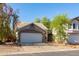 Home exterior featuring an attached two-car garage with an arched entryway and a concrete driveway at 3755 E Broadway Rd # 36, Mesa, AZ 85206