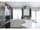 Bright kitchen featuring white cabinets, quartz countertops, stainless steel appliances, and backsplash at 3755 E Broadway Rd # 36, Mesa, AZ 85206
