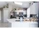 Well-lit kitchen features stainless steel appliances, white cabinetry, and a breakfast bar at 3755 E Broadway Rd # 36, Mesa, AZ 85206