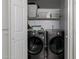Functional laundry room featuring modern washer and dryer units and built-in shelving for storage at 3755 E Broadway Rd # 36, Mesa, AZ 85206