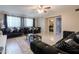 Living room featuring tile floors, black sofas, and a glass top coffee table at 3755 E Broadway Rd # 36, Mesa, AZ 85206