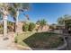 Beautiful backyard with lush green grass and palm trees at 3915 S 186Th Ln, Goodyear, AZ 85338