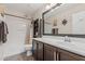 Bright bathroom featuring a shower-tub, a large mirror and a storage cabinet for convenience at 3915 S 186Th Ln, Goodyear, AZ 85338