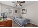 Comfortable bedroom with a ceiling fan, cozy bedding and a large window for ample natural light at 3915 S 186Th Ln, Goodyear, AZ 85338