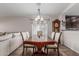 Elegant dining room featuring a spacious table and an open layout, adjacent to the living area at 3915 S 186Th Ln, Goodyear, AZ 85338