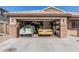 Attached two car garage shows ample space for storage or parking with two race cars at 3915 S 186Th Ln, Goodyear, AZ 85338