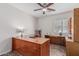 This office features a ceiling fan and built-in wooden desk at 3915 S 186Th Ln, Goodyear, AZ 85338