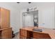 The office showcases a large wooden desk with an adjoining wall unit for ample storage at 3915 S 186Th Ln, Goodyear, AZ 85338