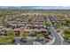 Wide aerial view of a meticulously planned neighborhood showcasing a mix of homes, lush trees, and distant mountains at 3932 E Melinda Dr, Phoenix, AZ 85050