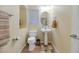 Clean, well-lit powder room featuring a pedestal sink, toilet, and neutral decor at 3932 E Melinda Dr, Phoenix, AZ 85050