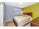 Inviting bedroom with a cozy queen bed, bedside table, soft lighting, and two-tone walls, creating a relaxing and stylish space at 3932 E Melinda Dr, Phoenix, AZ 85050
