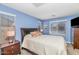 Comfortable bedroom featuring a queen-sized bed, soft blue walls, and ample natural light, creating a serene retreat at 3932 E Melinda Dr, Phoenix, AZ 85050