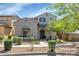 Beautiful two-story home featuring desert landscaping, an arched window, and a welcoming front entrance at 3932 E Melinda Dr, Phoenix, AZ 85050