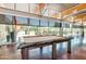 Game room with a billiard table and large windows offering views of the patio and green space at 3932 E Melinda Dr, Phoenix, AZ 85050