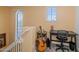 Bright hallway area with guitar, desk, and natural light from multiple windows, offering a cozy and inviting atmosphere at 3932 E Melinda Dr, Phoenix, AZ 85050