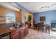 Open concept kitchen with stone countertops seamlessly flows into the dining area, perfect for entertaining guests at 3932 E Melinda Dr, Phoenix, AZ 85050
