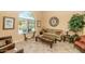 Bright living room with a decorative clock, comfortable couch, and arched window, creating a cozy atmosphere at 3932 E Melinda Dr, Phoenix, AZ 85050