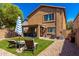 The backyard features artificial grass, comfortable lounge chairs, and a covered patio at 4034 E Mine Shaft Rd, San Tan Valley, AZ 85143