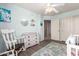A Bedroom featuring a rocking chair, changing table, and organized shelving, creating a practical and comforting space at 4034 E Mine Shaft Rd, San Tan Valley, AZ 85143