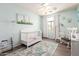 A charming Bedroom featuring a white crib, a cozy rocking chair, and soft, calming decor creating a serene atmosphere at 4034 E Mine Shaft Rd, San Tan Valley, AZ 85143