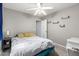 This bedroom has gray walls, a ceiling fan, and minimalist shelving, offering a serene and organized space at 4034 E Mine Shaft Rd, San Tan Valley, AZ 85143