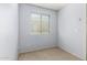 A serene spare bedroom, with plush carpet and soft lighting, offers comfort and is bathed in natural light at 4034 E Mine Shaft Rd, San Tan Valley, AZ 85143